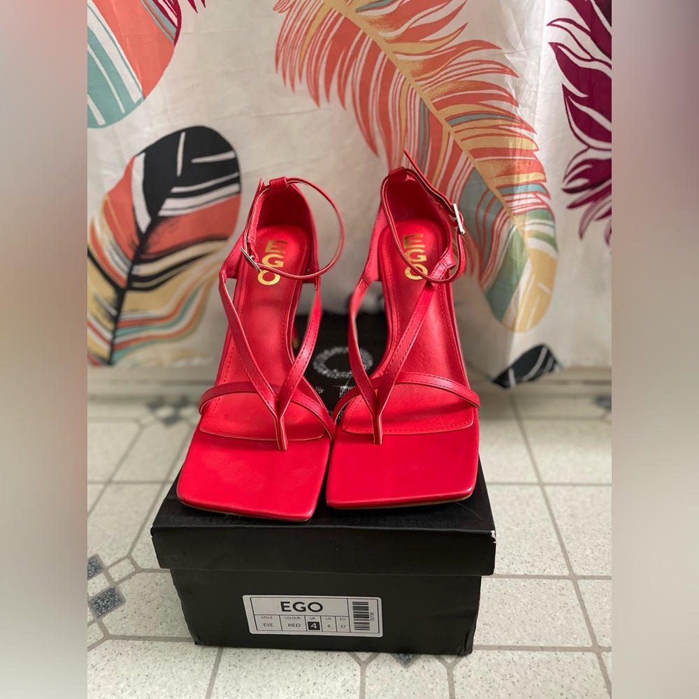 Square toe red strappy heel.